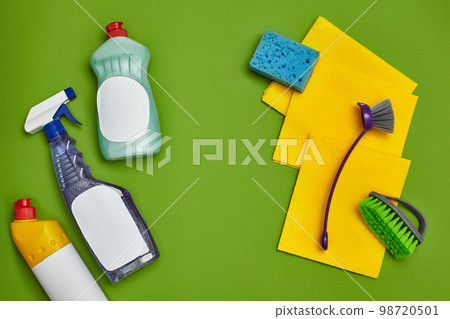 Detergents and cleaning accessories on a green background. Housekeeping concept. Detergents and cleaning accessories on a green background. Housekeeping concept. 98720501