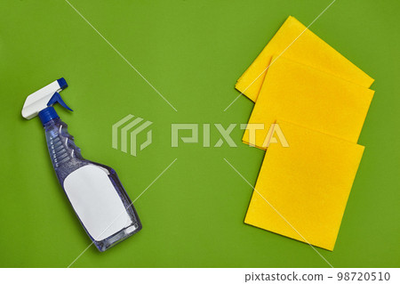 Detergents and cleaning accessories on a green background. Housekeeping concept. 98720510