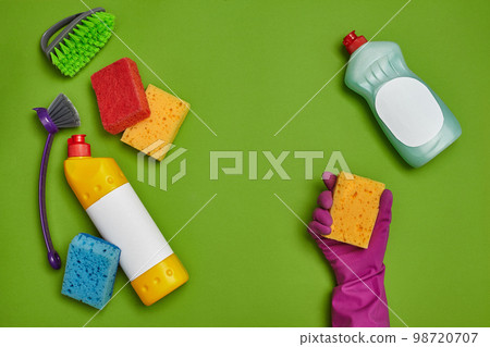 Detergents and cleaning accessories on a green background. Housekeeping concept. 98720707