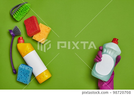 Detergents and cleaning accessories on a green background. Housekeeping concept. 98720708
