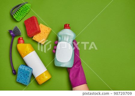 Detergents and cleaning accessories on a green background. Housekeeping concept. 98720709