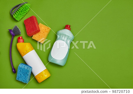 Detergents and cleaning accessories on a green background. Housekeeping concept. 98720710