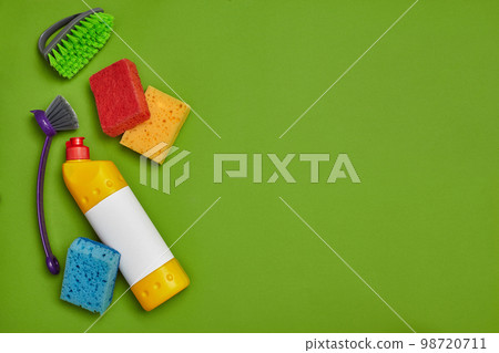 Detergents and cleaning accessories on a green background. Housekeeping concept. 98720711