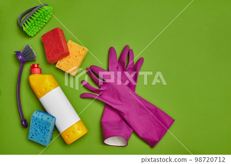 Detergents and cleaning accessories on a green background. Housekeeping concept. 98720712
