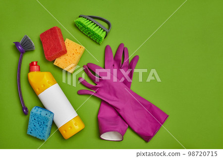 Detergents and cleaning accessories on a green background. Housekeeping concept. Detergents and cleaning accessories on a green background. Housekeeping concept. 98720715