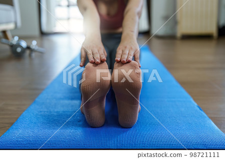 Healthy asian woman practicing relaxation yoga at home. Spending time and playing at home concept Healthy asian woman practicing relaxation yoga at home. Spending time and playing at home concept 98721111