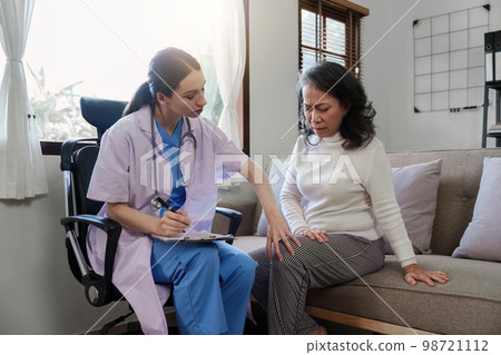 Home healthcare nurse, physical therapy with senior adult woman at home Home healthcare nurse, physical therapy with senior adult woman at home 98721112