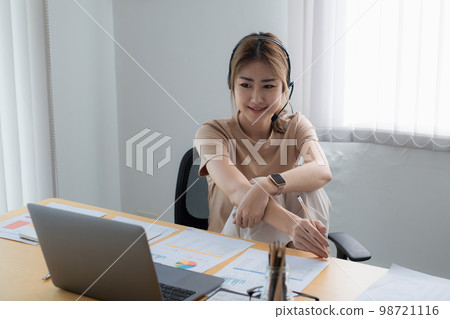 Businesswoman in having a video call on laptop while discussion with business partner during work from home. Businesswoman in having a video call on laptop while discussion with business partner during work from home. 98721116