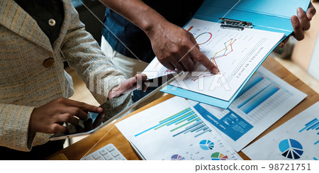 Marketing plan researching. Paperwork on the paperwork and doigital tablet on wooden desk in office. Brainstorming Group of people Working Concept. 98721751