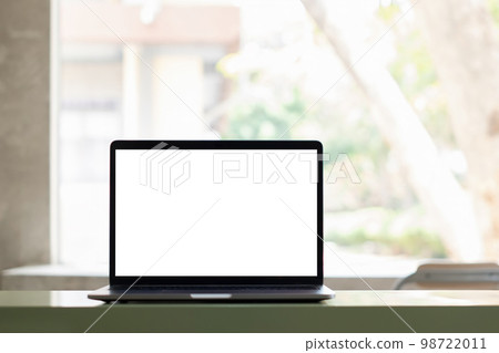 Mockup White blank screen laptop computer on modern working desk in home office with garden background. high quality image. 98722011