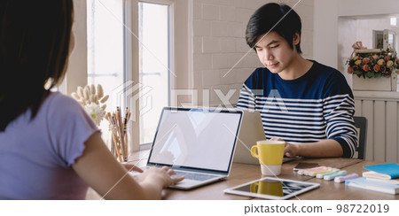 Asian student focus learning online course and watching video tutorial via laptop computer at living room in home,. online class room concept. Asian student focus learning online course and watching video tutorial via laptop computer at living room in home,. online class room concept. 98722019