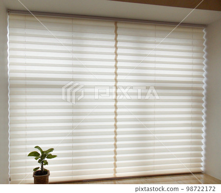 Pleated blinds XL, beige color, with 50mm fold closeup in the window opening in the interior. Home blinds - modern bottom up privacy shades on apartment windows.  98722172