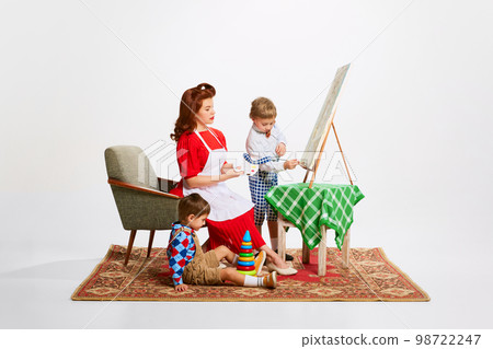 Hobby. Beautiful woman, mother playing with her sons, learning and drawing paintings together. Taking care after kids Hobby. Beautiful woman, mother playing with her sons, learning and drawing paintings together. Taking care after kids 98722247
