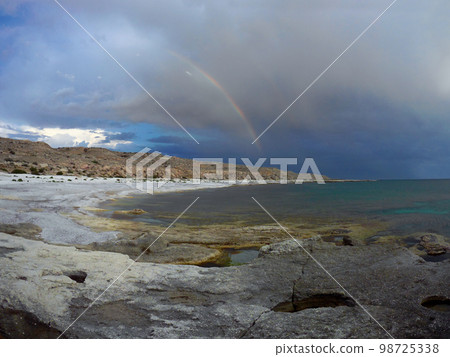 Rainbow over the sea. 98725338