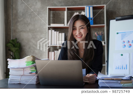 Beautiful Business woman working at home office and analyze financial report document. Accounting and Finance concept Beautiful Business woman working at home office and analyze financial report document. Accounting and Finance concept 98725749