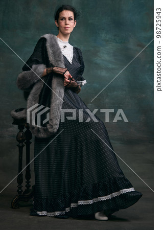 Femininity. Beautiful woman in image of Anna Karenina over vintage dark green background. Concept of literature character, history, old-fashioned Femininity. Beautiful woman in image of Anna Karenina over vintage dark green background. Concept of literature character, history, old-fashioned 98725943