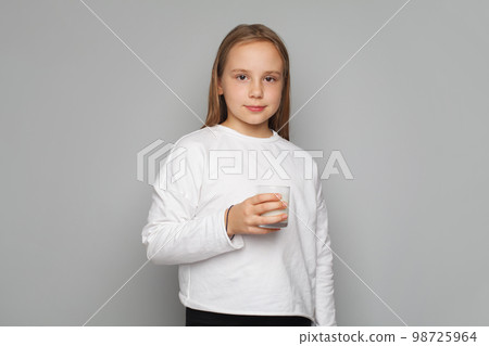 Pretty young child girl drinks milk without lactose, portrait 98725964