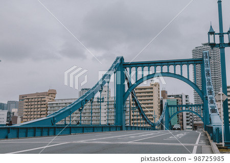 Railway bridge and road in cloudy weather Railway bridge and road in cloudy weather 98725985
