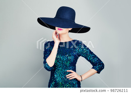 Glamorous Woman in Glitter Fashionable Dress and wide broad brim hat 98726211