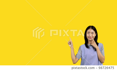 Asian woman pointing finger inviting click here, It is recommended to follow this direction or click on this link, Space for promotion here, Register or apply for membership, Click here. 98726475