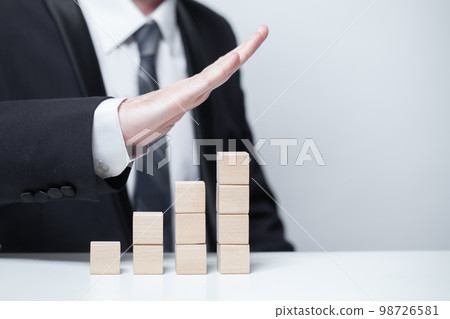 Wooden blank cubes, business growth success goal concept, businessman pointing up 98726581