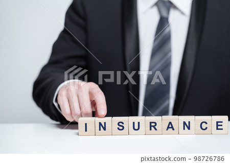 Wooden blocks with black word insurance, business insurance safety concept 98726786