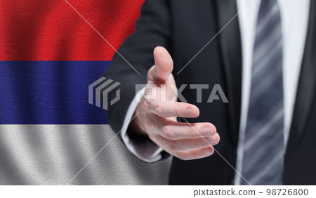 Serbian business, politics, cooperation and travel concept. Hand on flag of Serbia background. 98726800