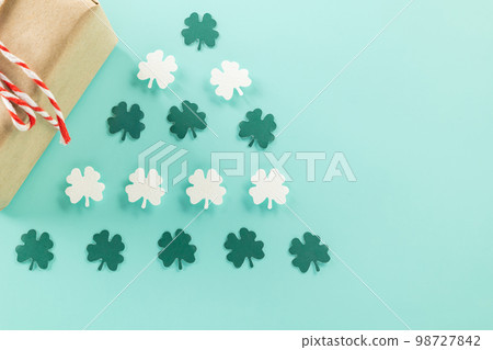 Happy St Patricks Day decoration background concept. shamrocks leaves holiday symbol with copy space on pastel background, above view gift box green clover leaves Happy St Patricks Day decoration background concept. shamrocks leaves holiday symbol with copy space on pastel background, above view gift box green clover leaves 98727842