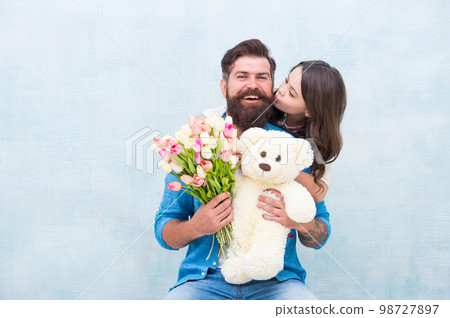 happy family of father and daughter embrace with spring tulip flower bouquet and teddy bear toy, fathers day happy family of father and daughter embrace with spring tulip flower bouquet and teddy bear toy, fathers day 98727897