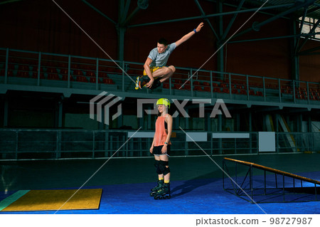 The man performs a trick. Jump. Indoor training The man performs a trick. Jump. Indoor training 98727987