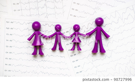 International Epilepsy Day, Epilepsy awareness. Purple toy adults and kids people, family on brain wave on electroencephalogram EEG for epilepsy International Epilepsy Day, Epilepsy awareness. Purple toy adults and kids people, family on brain wave on electroencephalogram EEG for epilepsy 98727996