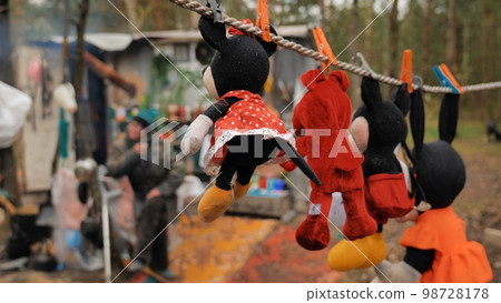 Stuffed toys are dried by homeless people in the forest. Stuffed toys are dried by homeless people in the forest. 98728178