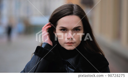 Portrait of a young girl on a city street in early spring. Portrait of a young girl on a city street in early spring. 98728275