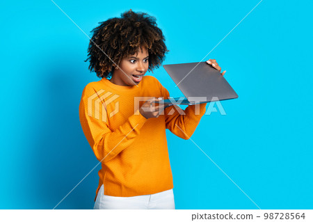 Amazed black woman open laptop and looking at sceen 98728564