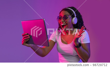 Amazing App. Excited Black Woman In Wireless Headphones Using Digital Tablet 98728712