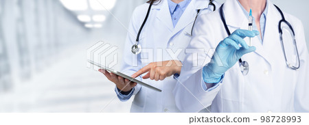 Cropped of medical staff discussing over digital pad at clinic 98728993