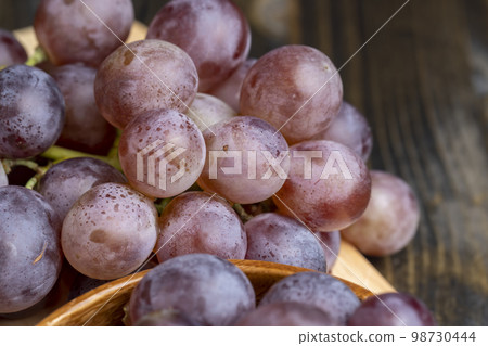 Ripe blue grapes on the kitchen table Ripe blue grapes on the kitchen table 98730444
