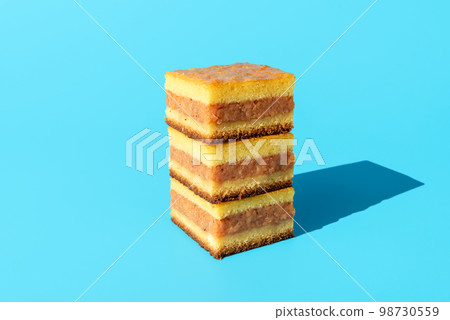 Apple cake slices isolated on a blue background Apple cake slices isolated on a blue background 98730559