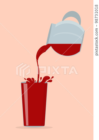 a red cherry tomato juice pours from a decanter into a transparent glass 98731018