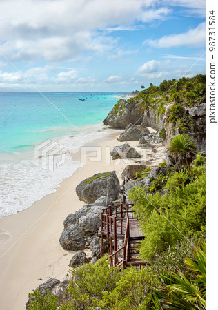 Rocky cliff at the tropical beach of Tulum, Yucatan Peninsula, Mexico. Rocky cliff at the tropical beach of Tulum, Yucatan Peninsula, Mexico. 98731584