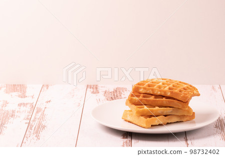 Delicious Belgian waffles served on white plate and wooden background, rustic concept, space for text Delicious Belgian waffles served on white plate and wooden background, rustic concept, space for text 98732402