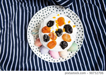 Easter eggs and Easter cake are on a plate, lying on a striped blue apron. Easter religious holiday concept. 98732706