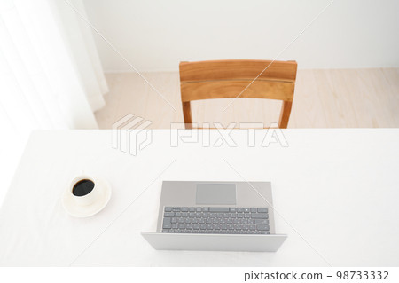 白色桌子上的筆記本電腦和咖啡杯（鍵盤焦點） 98733332