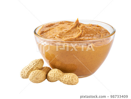 Glass bowl of peanut butter with peanuts isolated on white background 98733409