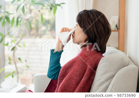 A middle-aged woman who suffers from hay fever A middle-aged woman who suffers from hay fever 98733690
