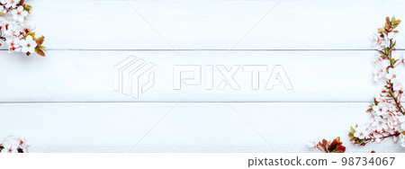 April floral nature banner. Spring blossom of may flowers on wooden. Branches of blossoming cherry against background. Copy space. April floral nature banner. Spring blossom of may flowers on wooden. Branches of blossoming cherry against background. Copy space. 98734067