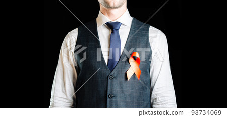 Hiv aids. Red ribbon in hiv world day isolated on dark background. Man holding awareness aids and cancer symbol. Health, Medical sign. copy space. Hiv aids. Red ribbon in hiv world day isolated on dark background. Man holding awareness aids and cancer symbol. Health, Medical sign. copy space. 98734069