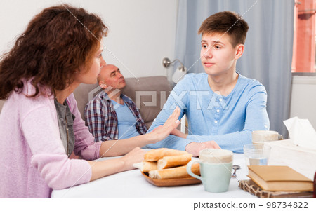 Teenager listening to reprimanding mother Teenager listening to reprimanding mother 98734822