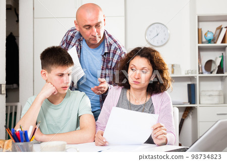 Family with son working with papers Family with son working with papers 98734823