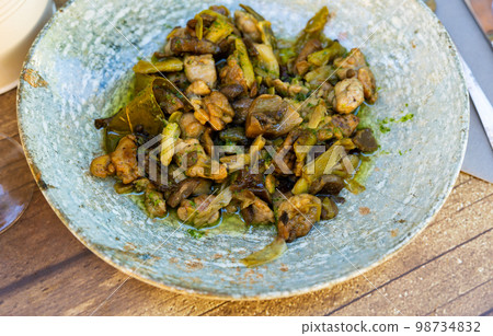 Portion of lechecillas de ternasco served on table Portion of lechecillas de ternasco served on table 98734832